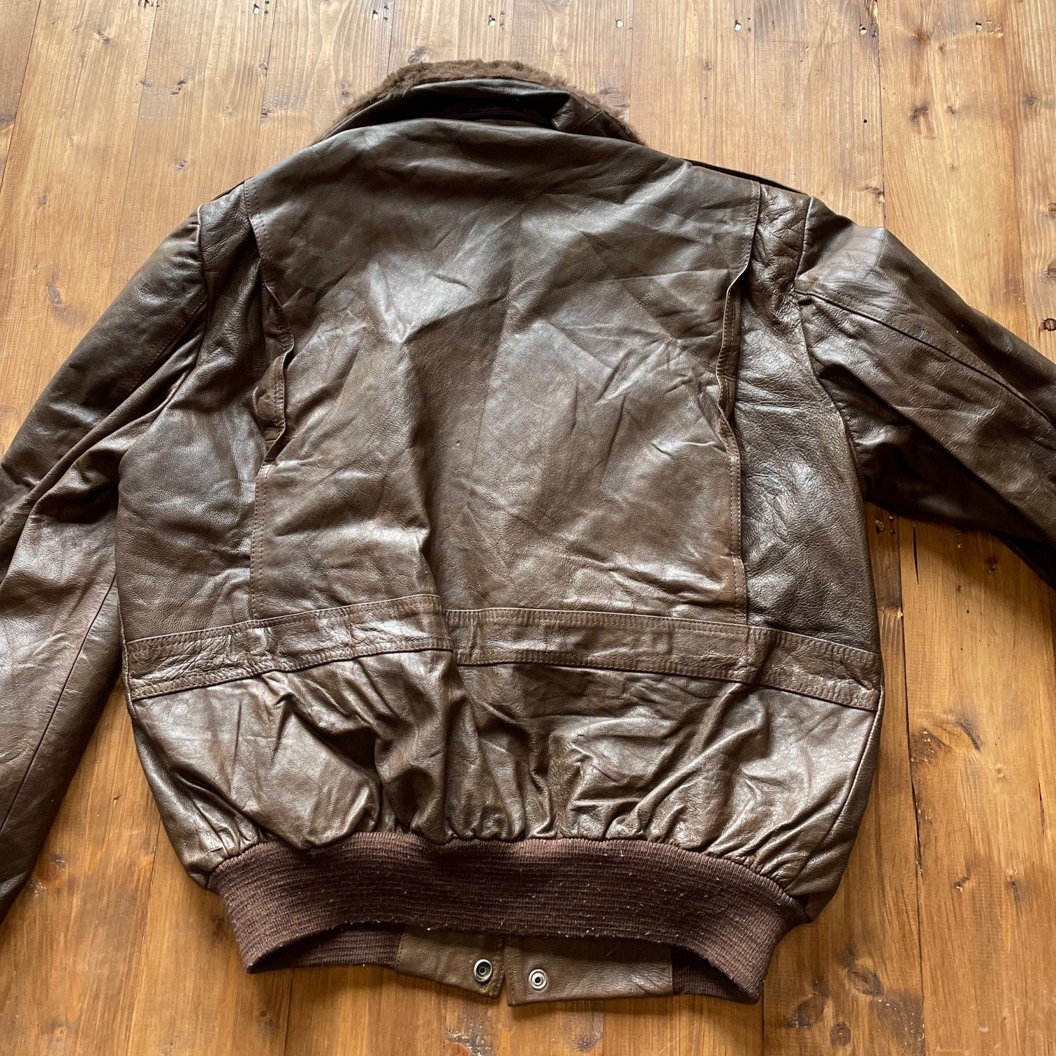 Brown leather flight jacket with detachable fur collar